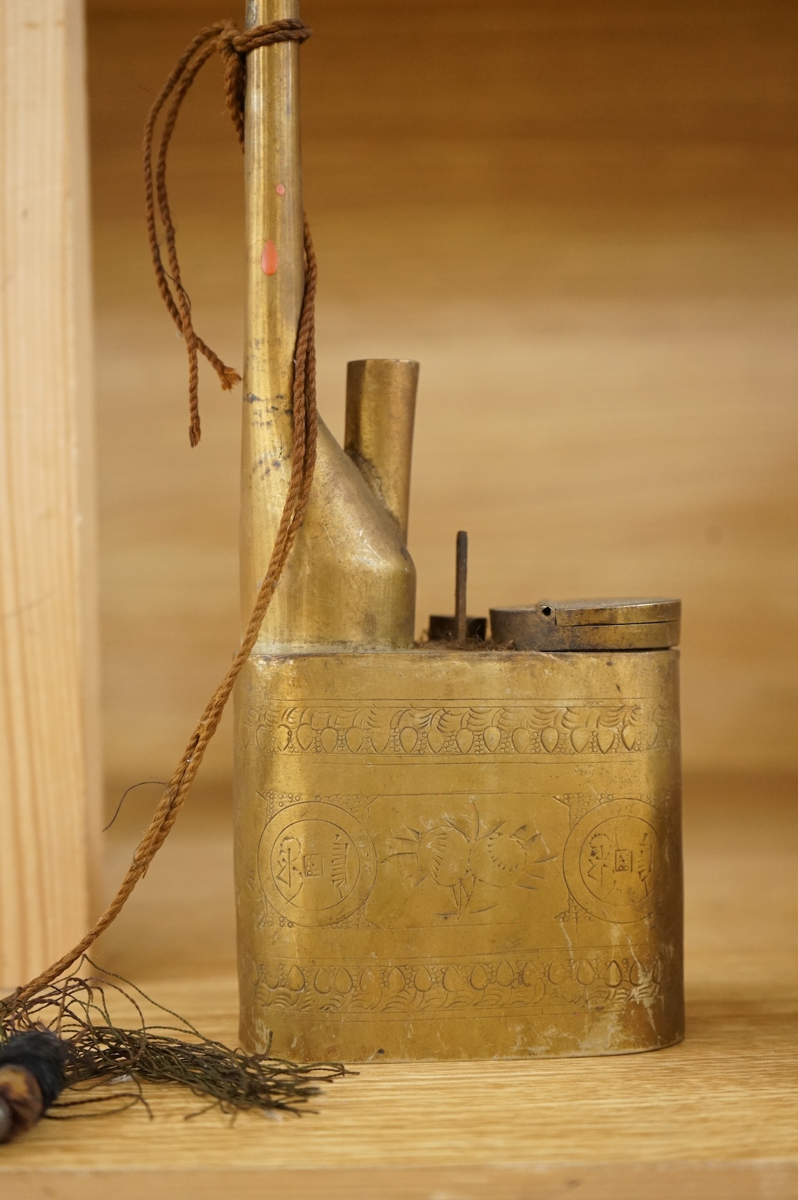 A Chinese cloisonné enamel and brass water pipe and an engraved example, largest 36cm high